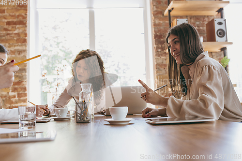 Image of Business young caucasian woman in modern office with team