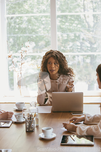 Image of Business young caucasian woman in modern office with team