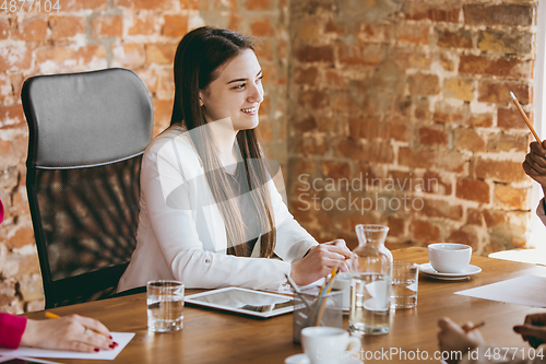 Image of Business young caucasian woman in modern office with team