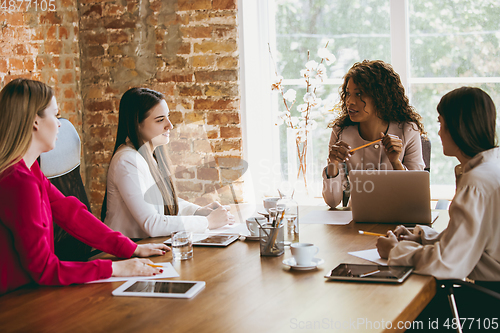 Image of Business young caucasian woman in modern office with team