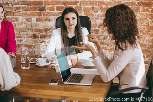 Image of Business young caucasian woman in modern office with team