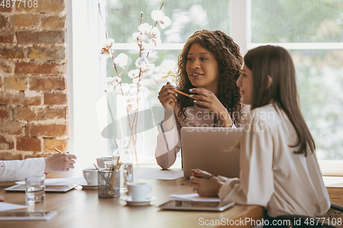 Image of Business young caucasian woman in modern office with team