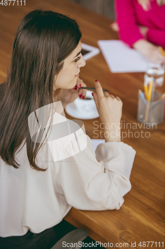 Image of Business young caucasian woman in modern office with team