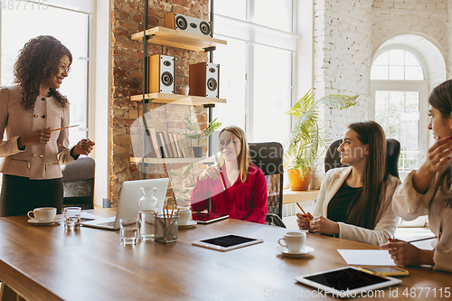 Image of Business young caucasian woman in modern office with team