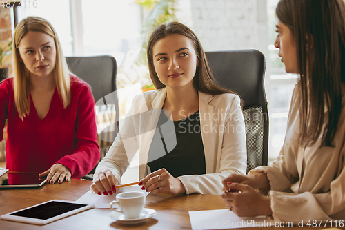 Image of Business young caucasian woman in modern office with team