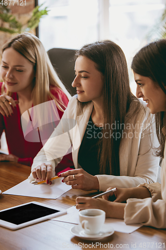 Image of Business young caucasian woman in modern office with team