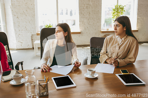 Image of Business young caucasian woman in modern office with team