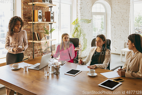 Image of Business young caucasian woman in modern office with team