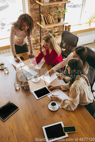 Image of Business young caucasian woman in modern office with team