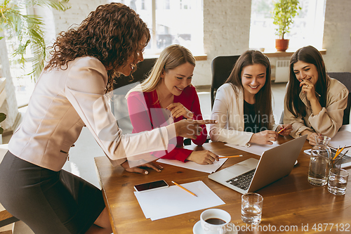 Image of Business young caucasian woman in modern office with team