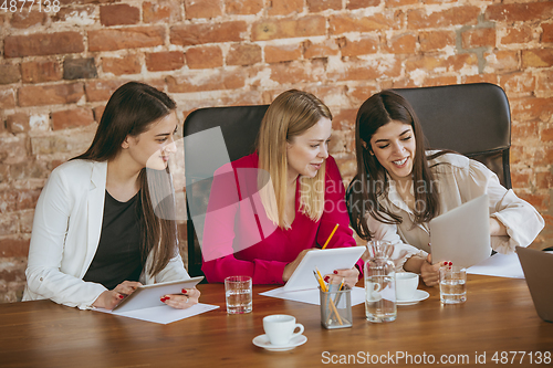 Image of Business young caucasian woman in modern office with team