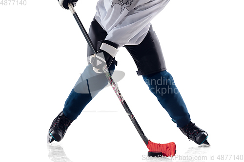 Image of Unrecognizable male hockey player with the stick on ice court and white background