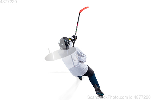 Image of Unrecognizable male hockey player with the stick on ice court and white background