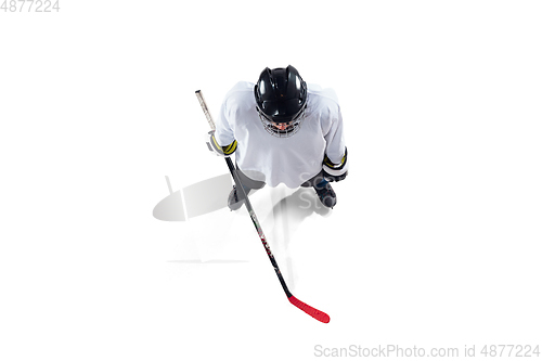 Image of Unrecognizable male hockey player with the stick on ice court and white background