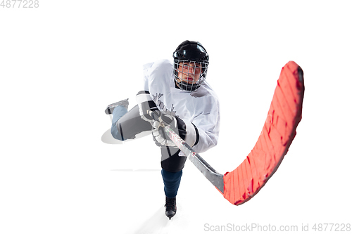 Image of Unrecognizable male hockey player with the stick on ice court and white background