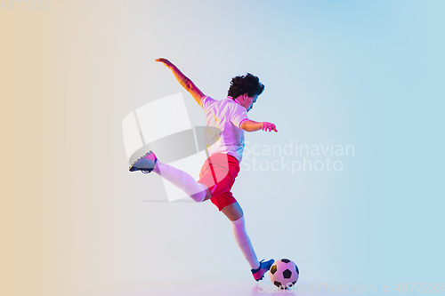 Image of Football or soccer player on gradient background in neon light - motion, action, activity concept