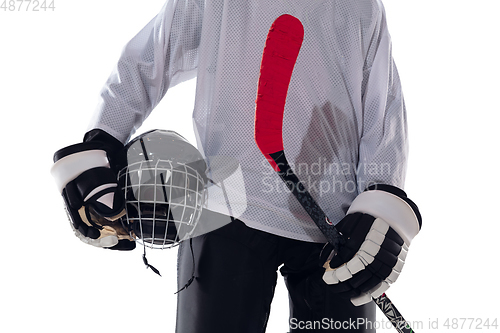 Image of Unrecognizable male hockey player with the stick on ice court and white background