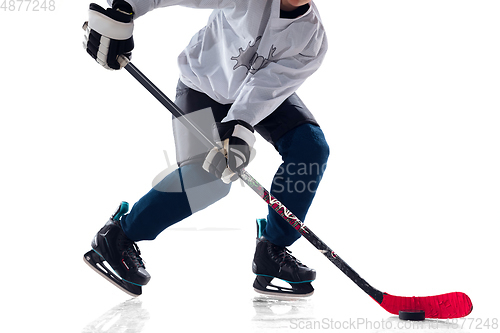 Image of Unrecognizable male hockey player with the stick on ice court and white background