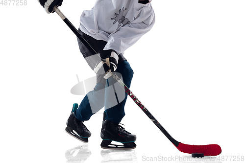 Image of Unrecognizable male hockey player with the stick on ice court and white background