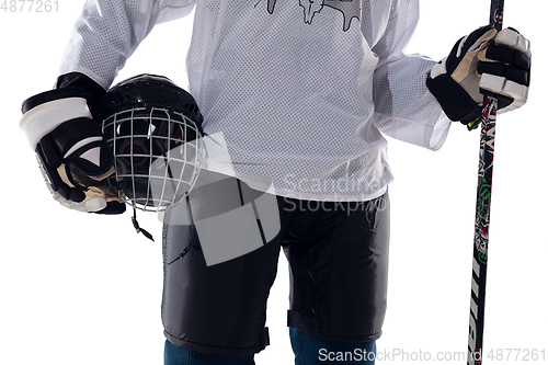 Image of Unrecognizable male hockey player with the stick on ice court and white background