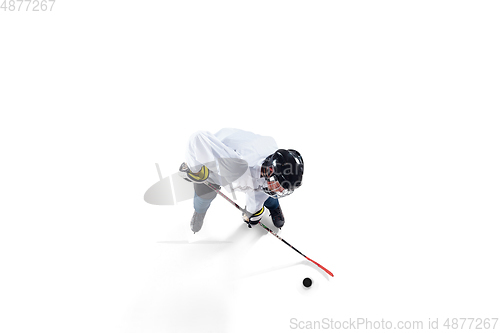 Image of Unrecognizable male hockey player with the stick on ice court and white background