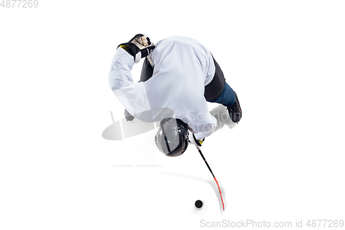 Image of Unrecognizable male hockey player with the stick on ice court and white background