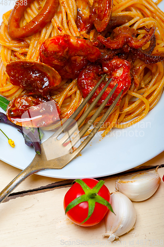 Image of Italian seafood spaghetti pasta on red tomato sauce