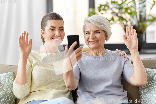 Image of daughter and old mother having video call on phone