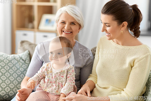 Image of mother, daughter and grandmother on sofa at home