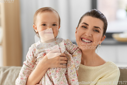 Image of happy mother with little baby daughter at home