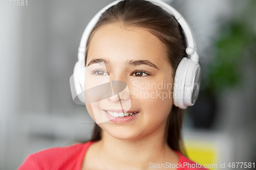 Image of girl in headphones listening to music at home