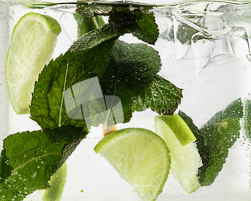 Image of Close up view of the cold and fresh lemonade with light and mint, ice cubes