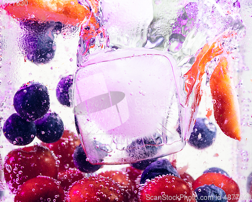 Image of Close up view of the cold and fresh lemonade with bright berries in neon light