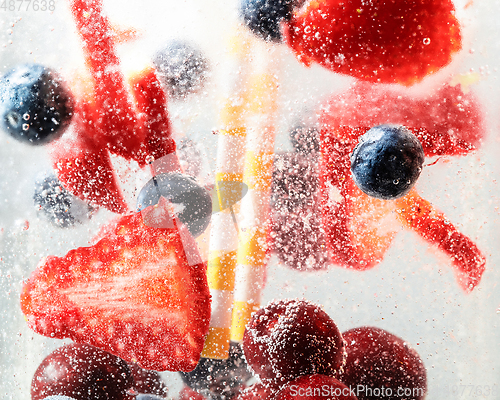 Image of Close up view of the cold and fresh lemonade with bright berries in neon light