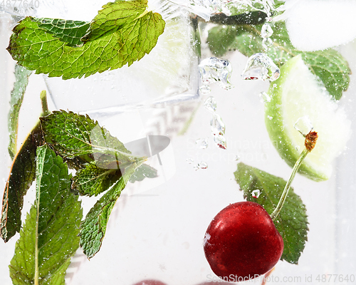 Image of Close up view of the cold and fresh lemonade with bright berries in neon light