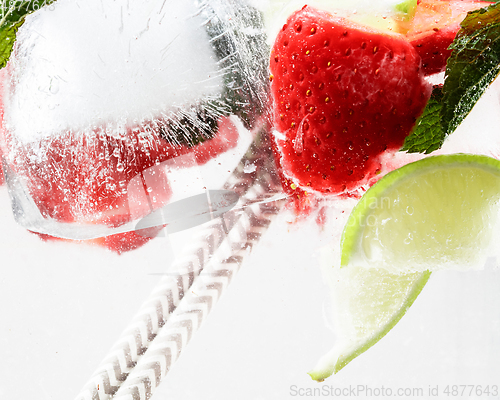 Image of Close up view of the cold and fresh lemonade with bright berries in neon light