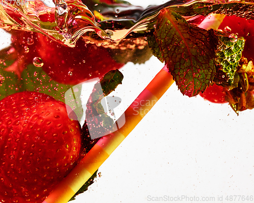 Image of Close up view of the cold and fresh lemonade with bright berries in neon light