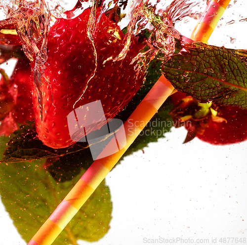 Image of Close up view of the cold and fresh lemonade with bright berries in neon light