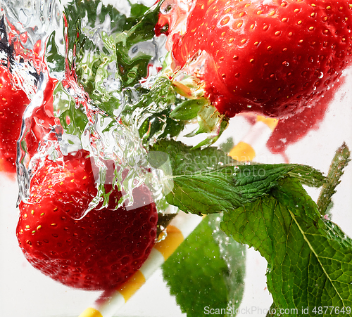 Image of Close up view of the cold and fresh lemonade with bright berries in neon light