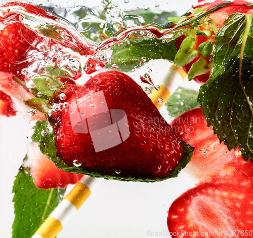 Image of Close up view of the cold and fresh lemonade with bright berries in neon light