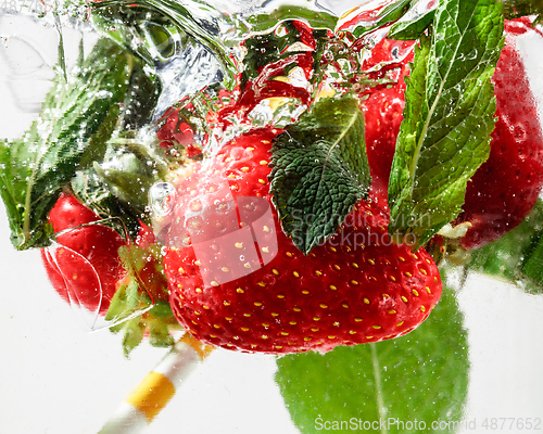 Image of Close up view of the cold and fresh lemonade with bright berries in neon light