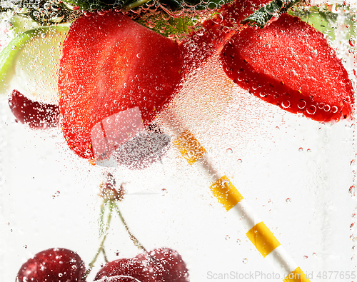 Image of Close up view of the cold and fresh lemonade with bright berries in neon light