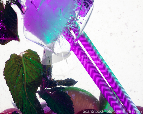 Image of Close up view of the cold and fresh lemonade with bright berries in neon light