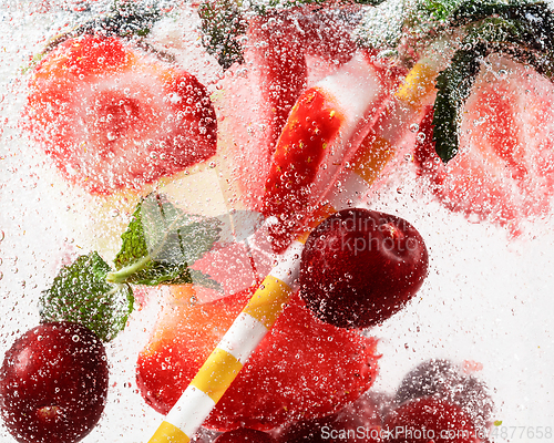 Image of Close up view of the cold and fresh lemonade with bright berries in neon light