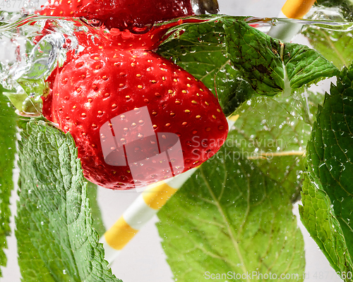 Image of Close up view of the cold and fresh lemonade with bright berries in neon light