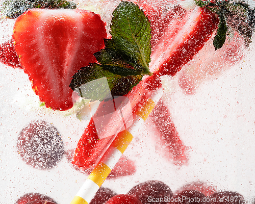 Image of Close up view of the cold and fresh lemonade with bright berries in neon light