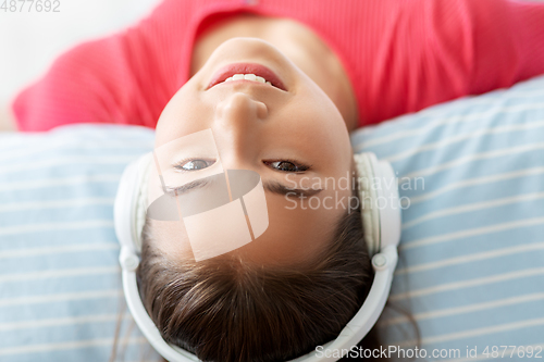 Image of girl in headphones listening to music at home