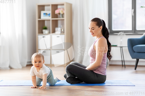 Image of happy mother with little baby at home