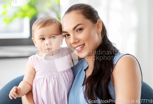 Image of happy mother with little baby daughter at home