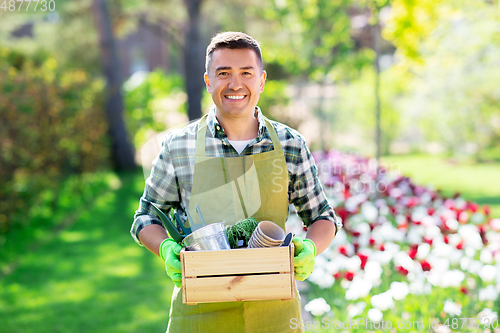 Image of happy man with tools in box at summer garden